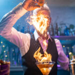 Bartender making a fire flame cocktail in a elegant night club party unique experience. . High quality photo